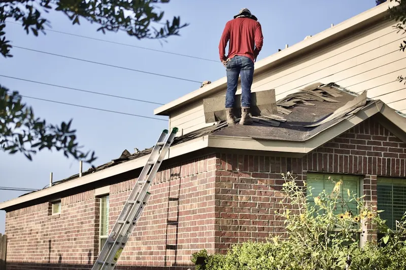 Professional roofer working on a residential roof in Jacksonville Farms-Terrace